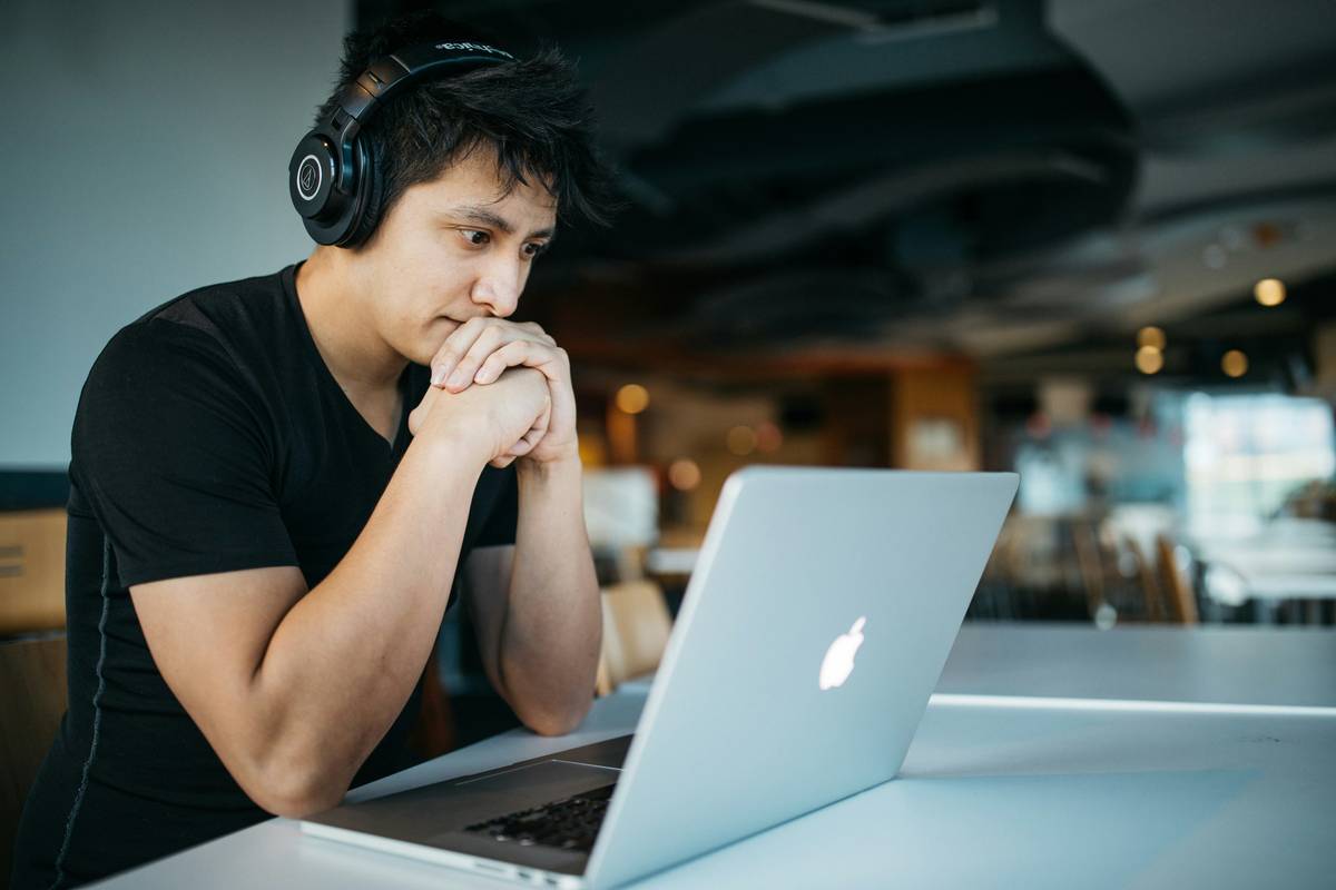 Student coding a basic C++ game using game development mcc curriculum materials on dual monitors