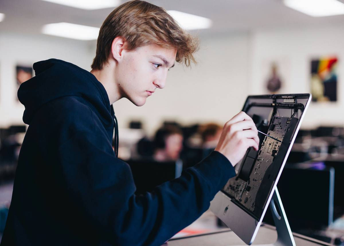 Student debugging C++ game code with data structures development education notes on screen